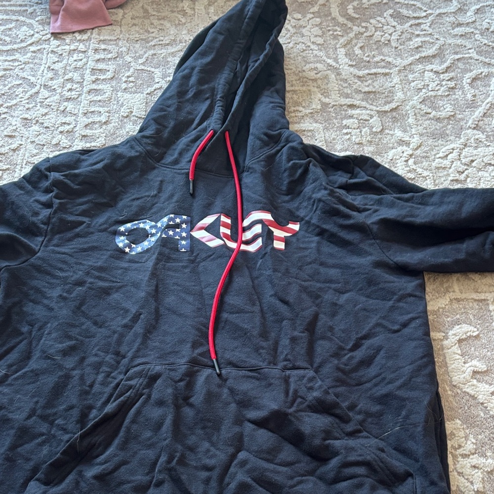 Oakley Black Hoodie with Patriotic Logo and Red Strings